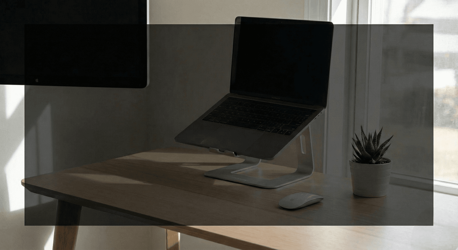 Minimalist home office setup with laptop stand and ergonomic gear for productivity
